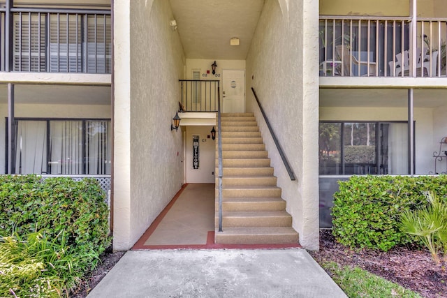 view of exterior entry featuring stucco siding