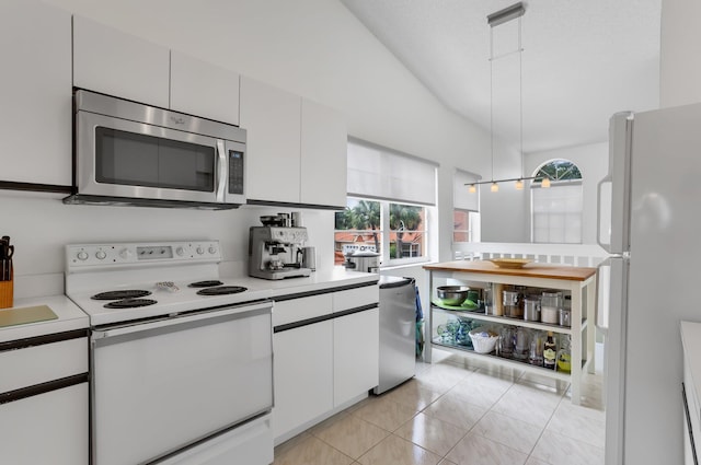 9927 Seacrest Cir Unit 202, Boynton Beach, FL 33437 - kitchen with lofted ceiling, light tile patterned flooring, light countertops, a sink, and appliances with stainless steel finishes