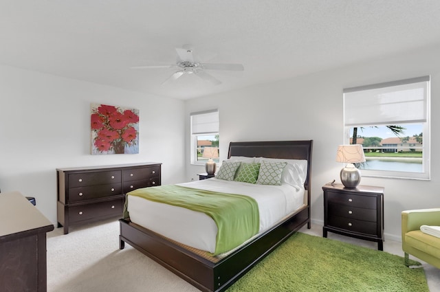 9927 Seacrest Cir Unit 202, Boynton Beach, FL 33437 - carpeted bedroom with baseboards, multiple windows, and a ceiling fan