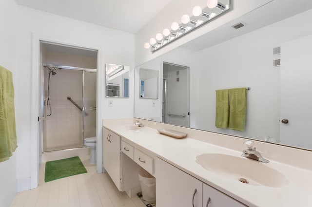 9927 Seacrest Cir Unit 202, Boynton Beach, FL 33437 - full bathroom featuring a sink, double vanity, toilet, visible vents, and a stall shower