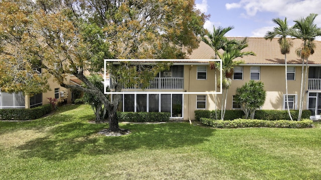 9927 Seacrest Cir Unit 202, Boynton Beach, FL 33437 - rear view of house with stucco siding, a yard, and a tile roof