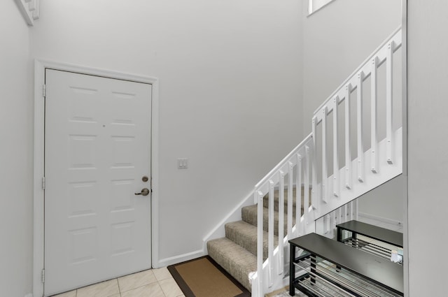 9927 Seacrest Cir Unit 202, Boynton Beach, FL 33437 - entryway featuring baseboards, stairs, and light tile patterned floors