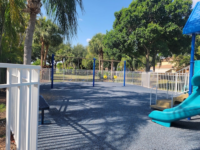 view of community featuring fence and playground community