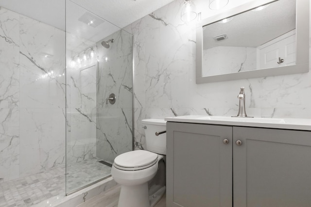 bathroom featuring a marble finish shower, marble finish floor, toilet, and vanity