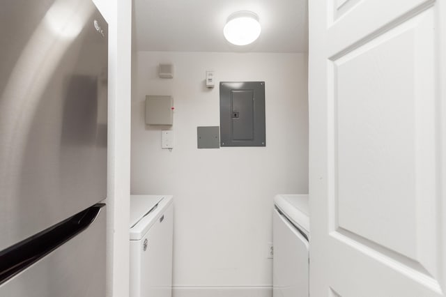 laundry area with washer and clothes dryer, laundry area, and electric panel