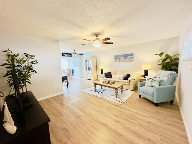 14 Colonial Club Dr Unit 102, Boynton Beach, FL 33435 - living room with a ceiling fan, light wood-type flooring, a textured ceiling, and baseboards