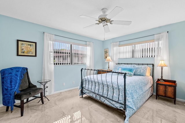 bedroom featuring baseboards and ceiling fan