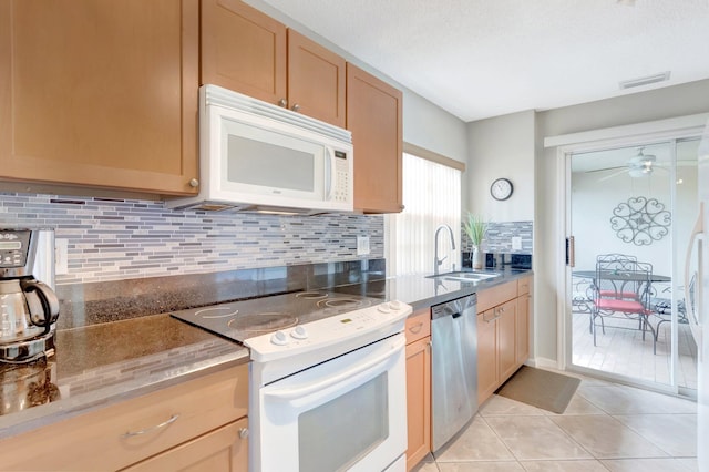 6488 Via Regina, Boca Raton, FL 33433 - kitchen featuring white appliances, visible vents, light tile patterned flooring, a sink, and decorative backsplash