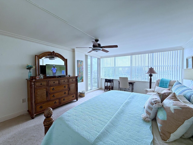 carpeted bedroom with crown molding, a ceiling fan, and baseboards