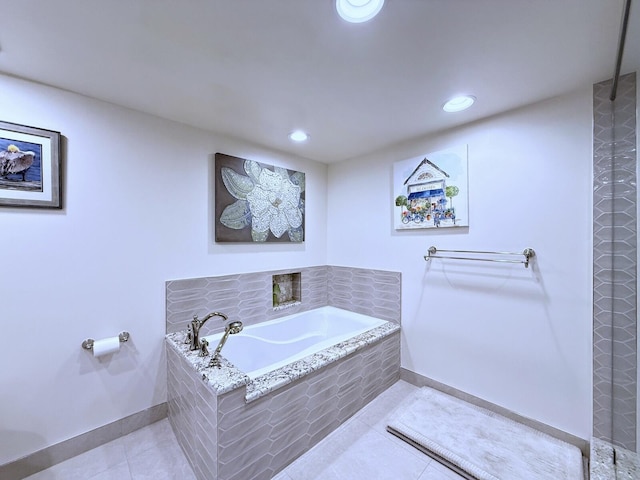 bathroom with recessed lighting, a bath, tile patterned flooring, and baseboards