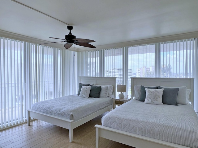 bedroom with ceiling fan and wood finished floors