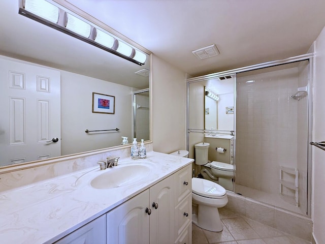 bathroom featuring toilet, tile patterned flooring, a shower stall, and vanity