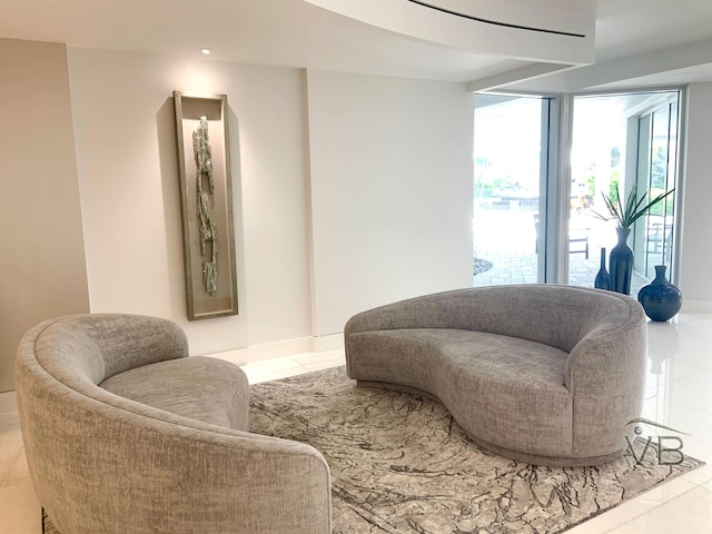 living area featuring baseboards