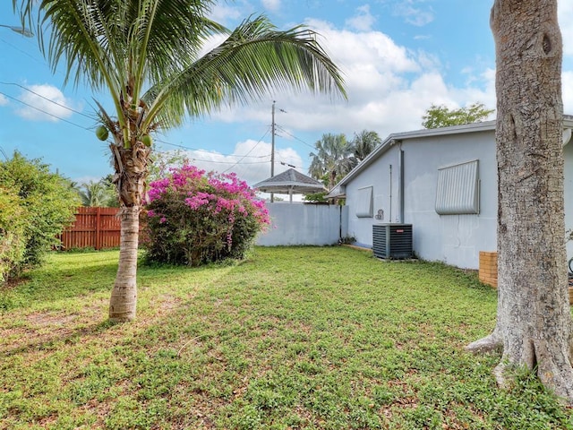 view of yard with fence and cooling unit