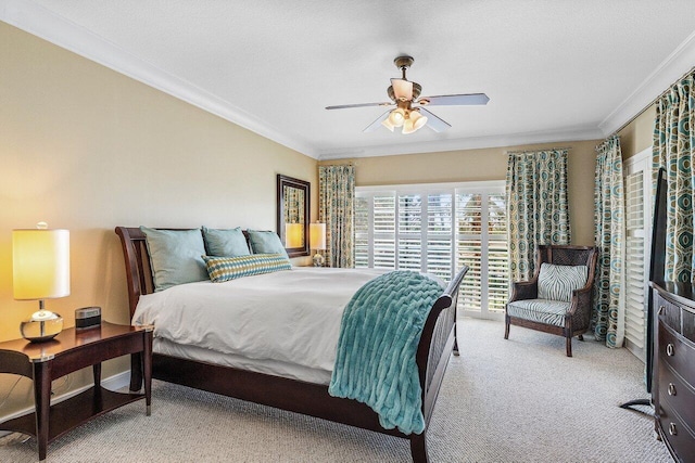 carpeted bedroom featuring crown molding and a ceiling fan