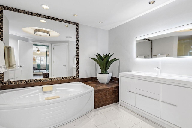 ensuite bathroom with vanity, recessed lighting, tile patterned flooring, connected bathroom, and a garden tub