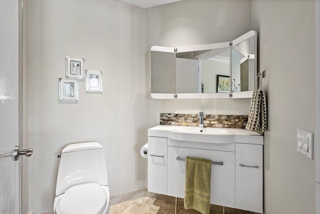 bathroom featuring toilet and vanity