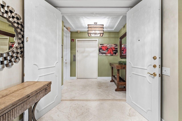 foyer entrance with baseboards and marble finish floor