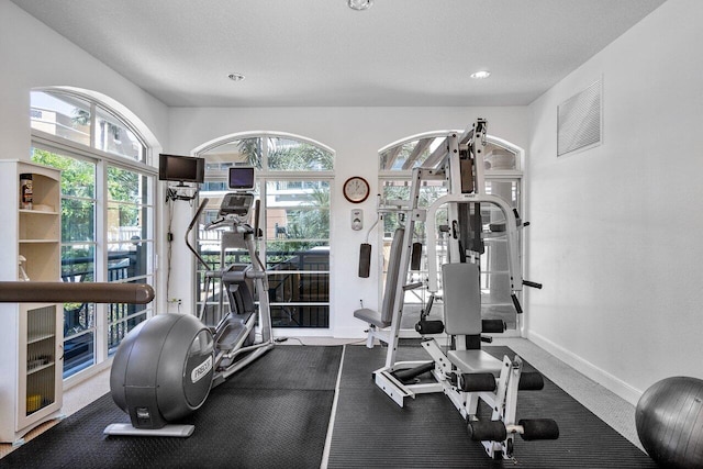 exercise area with visible vents and baseboards