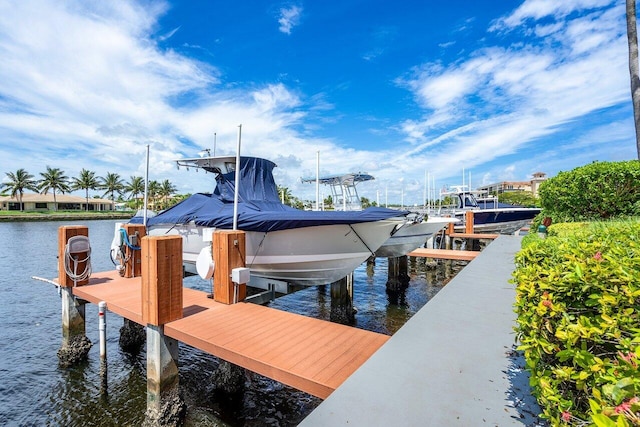 dock area with a water view and boat lift