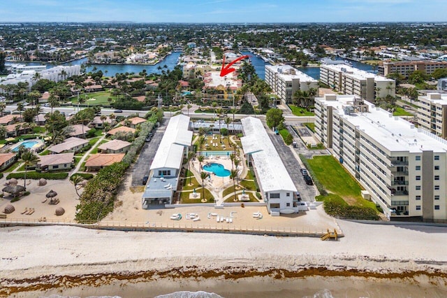 birds eye view of property featuring a water view and a city view