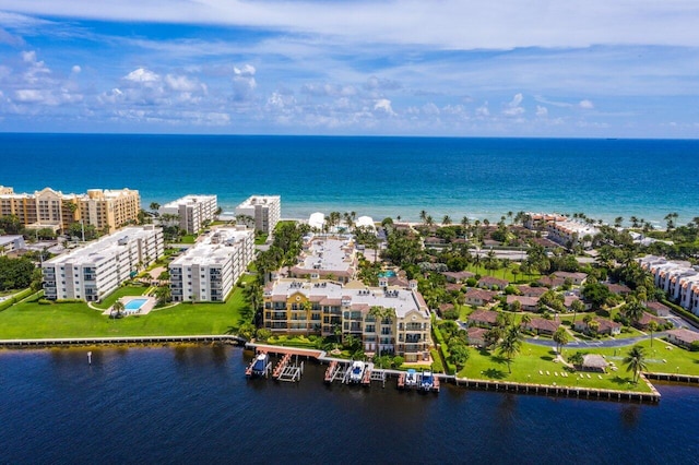 birds eye view of property with a city view and a water view