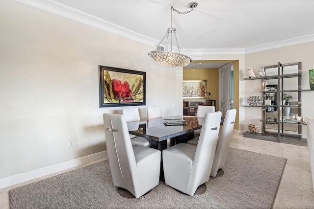 dining area with a chandelier, crown molding, and baseboards