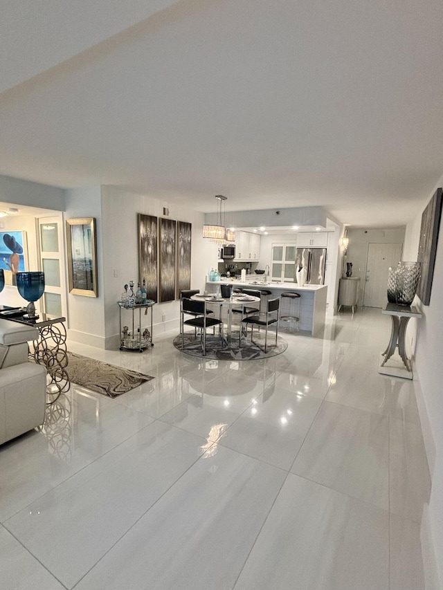 3400 S Ocean Blvd Unit 3H, Highland Beach, FL 33487 - living room with baseboards and light tile patterned flooring