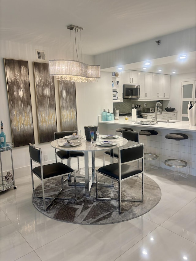 3400 S Ocean Blvd Unit 3H, Highland Beach, FL 33487 - dining area featuring a chandelier and light tile patterned floors