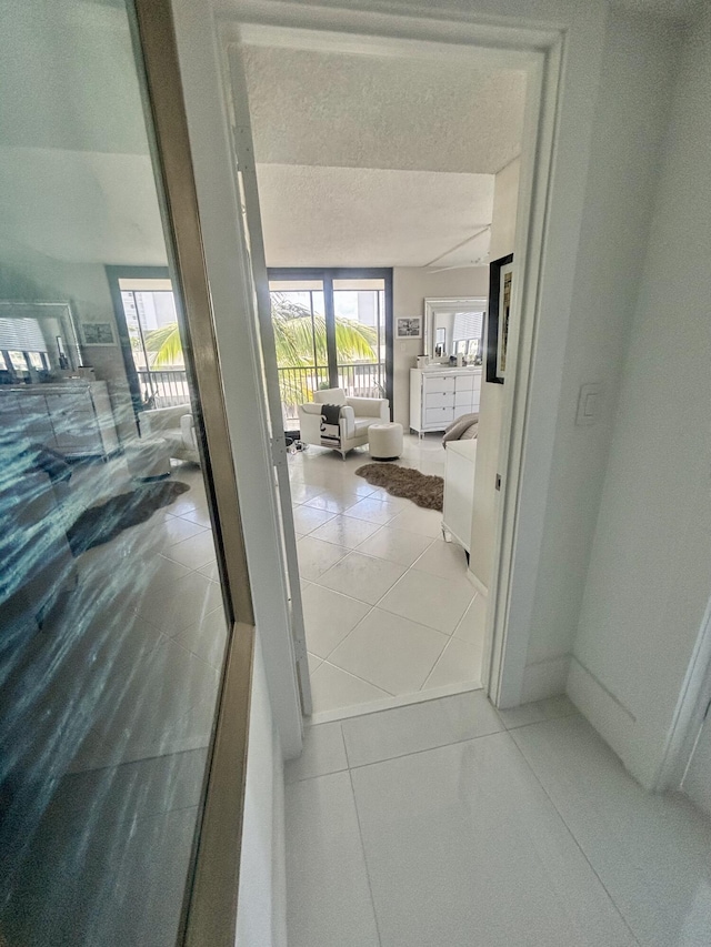 3400 S Ocean Blvd Unit 3H, Highland Beach, FL 33487 - corridor with a textured ceiling and light tile patterned floors