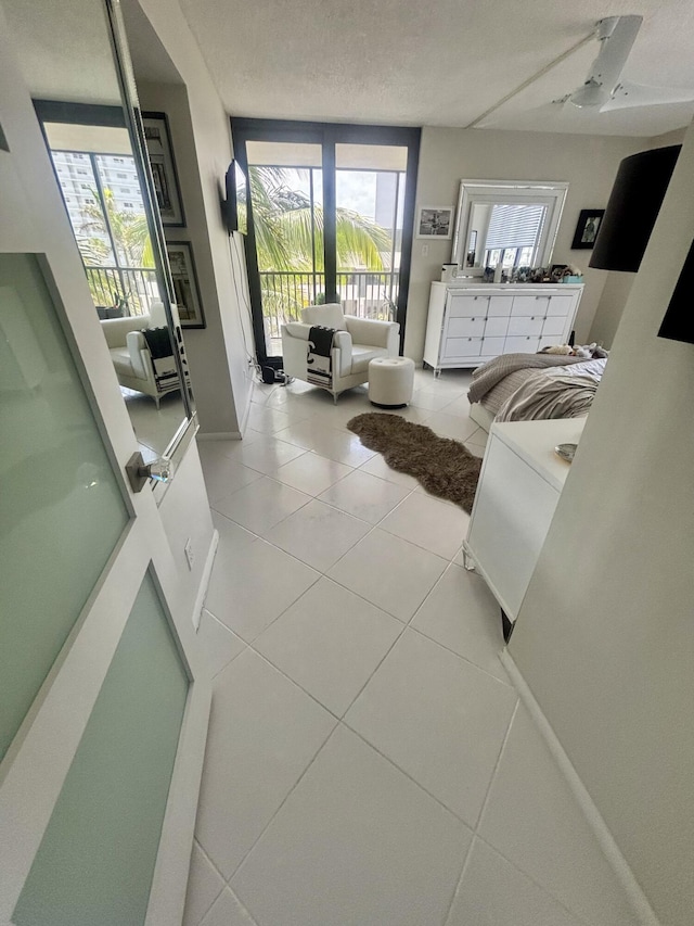 3400 S Ocean Blvd Unit 3H, Highland Beach, FL 33487 - living area with light tile patterned floors, a textured ceiling, and a ceiling fan