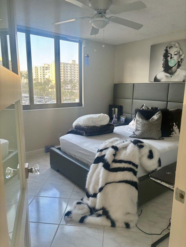 3400 S Ocean Blvd Unit 3H, Highland Beach, FL 33487 - bedroom with a textured ceiling, ceiling fan, and a city view