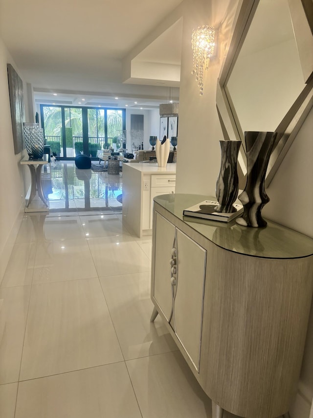 3400 S Ocean Blvd Unit 3H, Highland Beach, FL 33487 - corridor with light tile patterned flooring, a chandelier, and a wall of windows