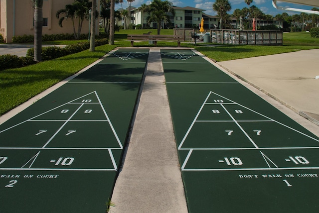 2400 S Ocean Dr Unit 1216, Fort Pierce, FL 34949 - surrounding community with shuffleboard, fence, and a lawn