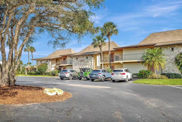 2400 S Ocean Dr Unit 1216, Fort Pierce, FL 34949 - view of property featuring uncovered parking, stucco siding, and stone siding