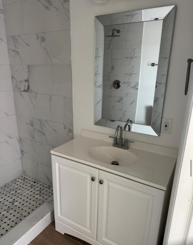 bathroom featuring vanity and a shower stall