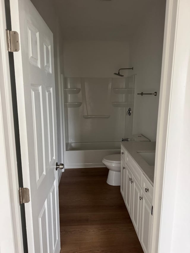full bathroom with vanity, toilet, shower / bathtub combination, and wood finished floors