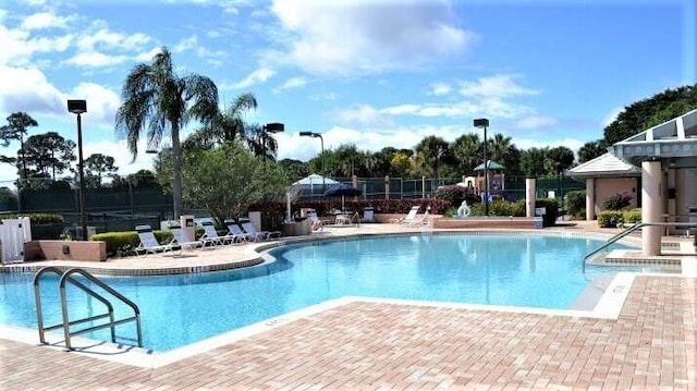 pool featuring a patio area and fence
