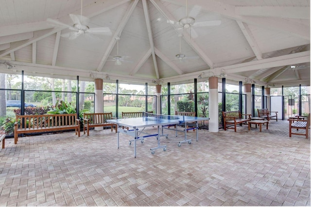 sunroom featuring ceiling fan, high vaulted ceiling, and outdoor dining area