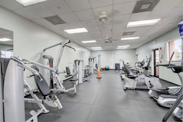 workout area with a ceiling fan and a paneled ceiling