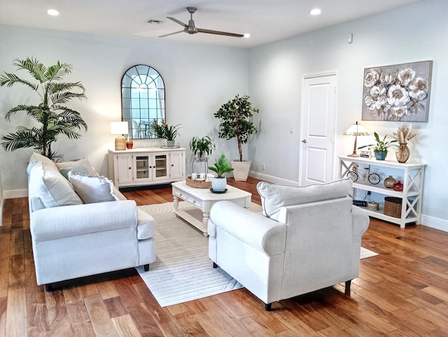 living room with a ceiling fan, visible vents, wood finished floors, baseboards, and recessed lighting