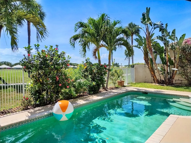1219 Avondale Ln, West Palm Beach, FL 33409 - view of swimming pool with a fenced backyard