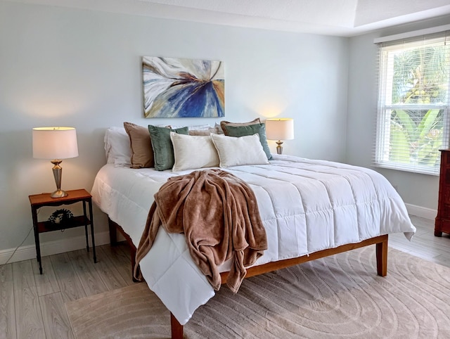 bedroom featuring baseboards and light wood-type flooring
