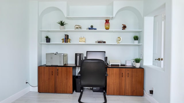 home office featuring baseboards and light wood finished floors