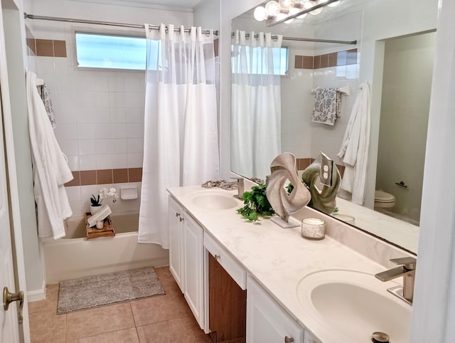 full bath featuring double vanity, tile patterned floors, a sink, and shower / bath combo with shower curtain