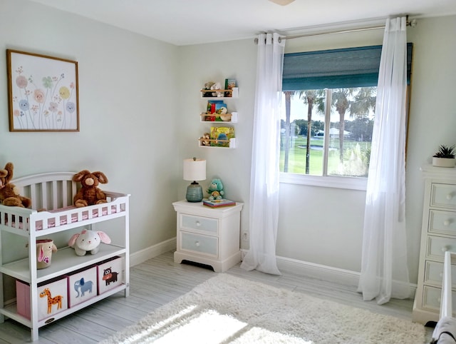 bedroom featuring baseboards and wood finished floors