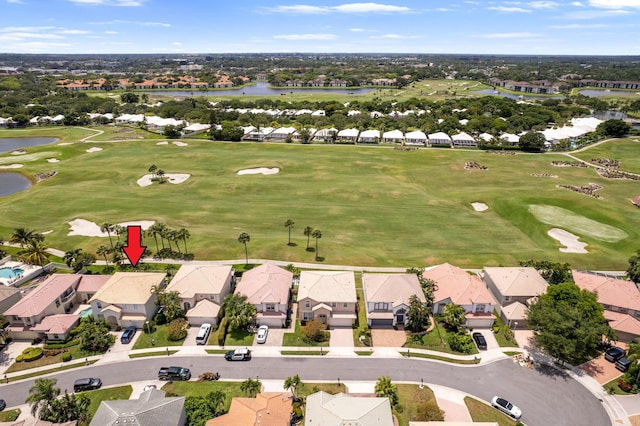 aerial view featuring a water view, golf course view, and a residential view