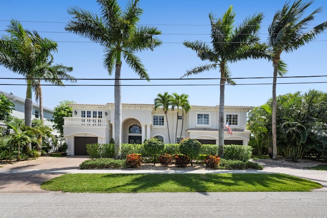 712 NE 71st St, Boca Raton, FL 33487 - view of front of house with stucco siding, a tile roof, a balcony, an attached garage, and driveway