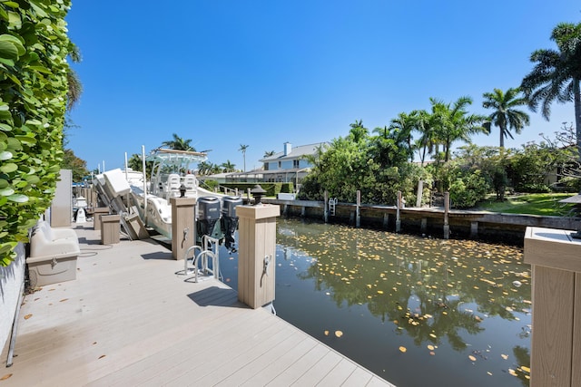 712 NE 71st St, Boca Raton, FL 33487 - view of dock featuring boat lift and a water view