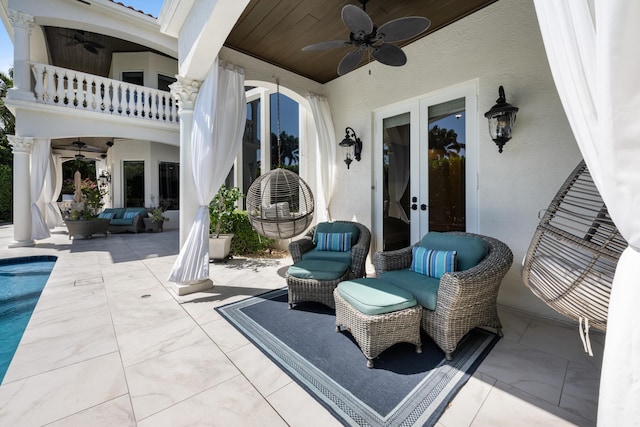 712 NE 71st St, Boca Raton, FL 33487 - view of patio / terrace with an outdoor pool, a ceiling fan, french doors, and a balcony